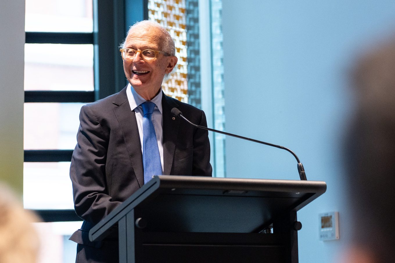 Professor Henry Brodaty AO speaking at a lectern.